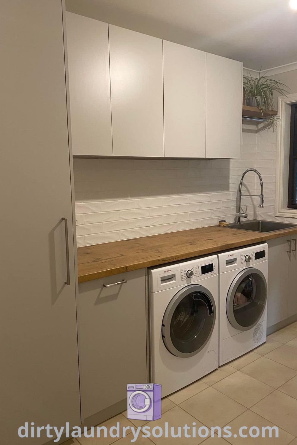 A small utility room featuring a washer and dryer, showcasing long utility room ideas, L shape laundry designs, and efficient organization solutions. Discover more inspiring ideas for your home at dirtylaundrysolutions.com.