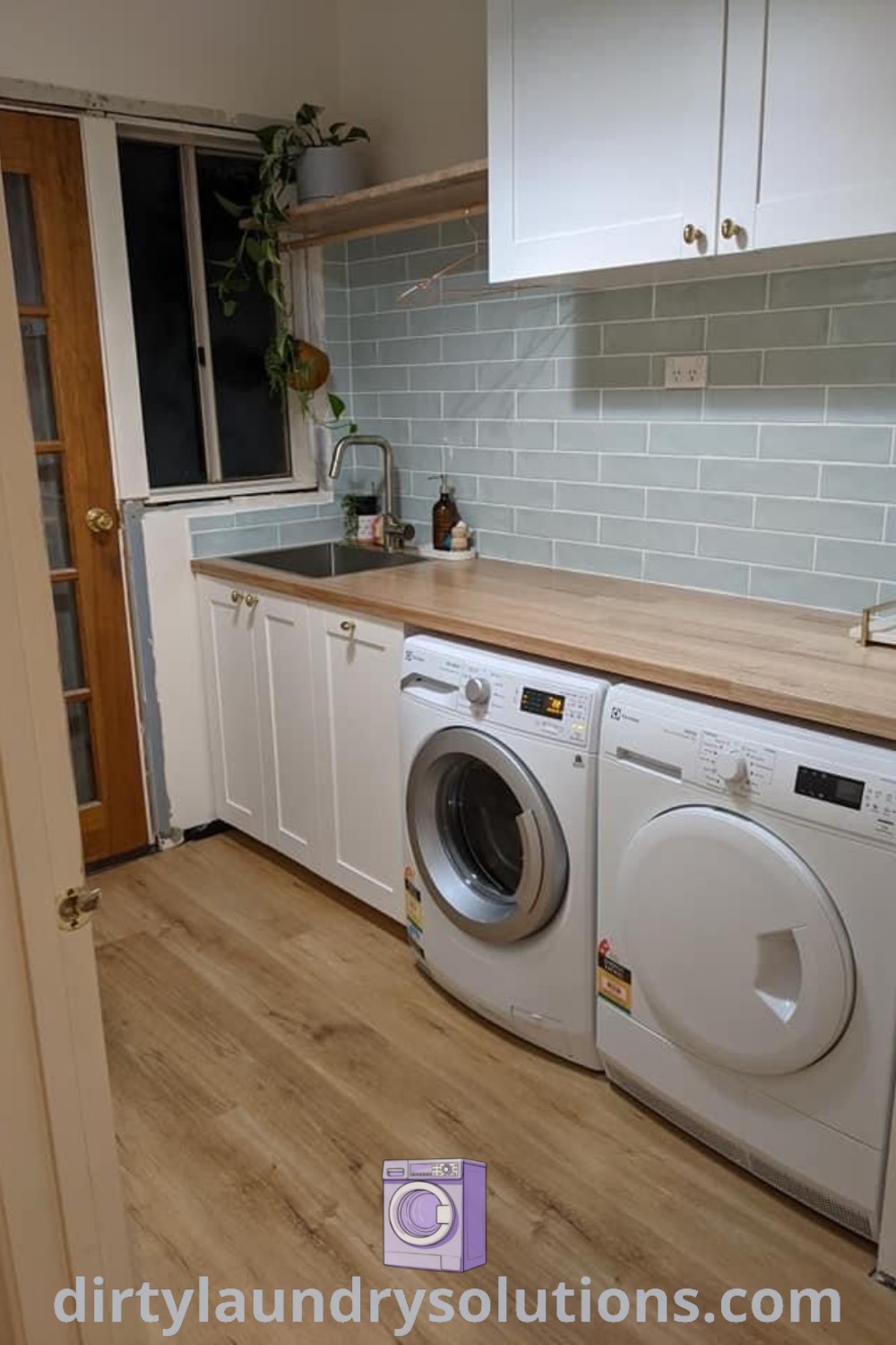 A washer and dryer in a beautifully designed beach house utility room with hardwood floors, showcasing Australian laundry ideas and organization solutions. Discover more inspiring laundry room designs at dirtylaundrysolutions.com.