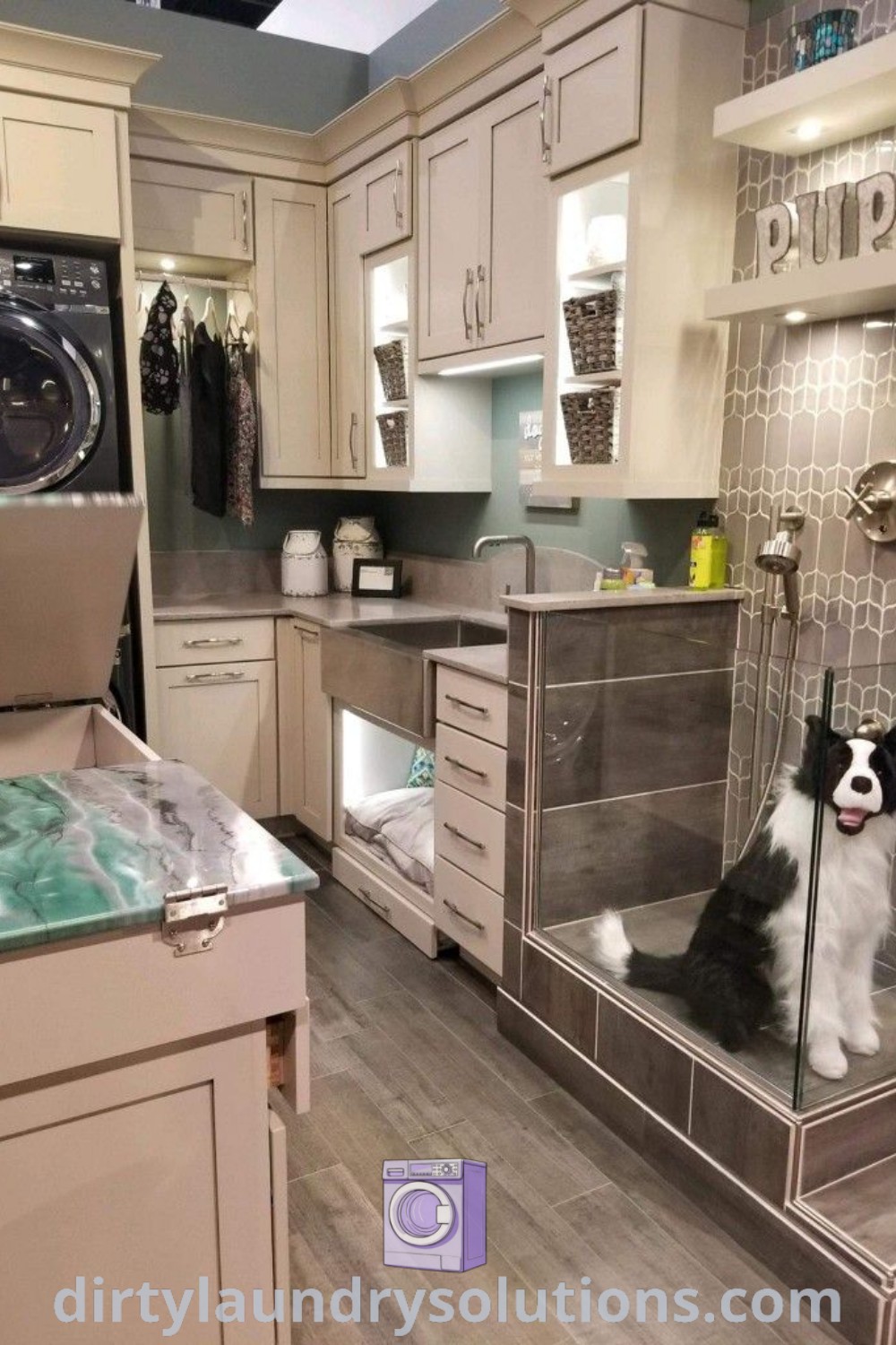 A dog sitting in a glass enclosed shower area next to an oven and washer, exemplifying a cozy dog laundry room with a dog wash station, showcasing ideas for unique and functional spaces at dirtylaundrysolutions.com.