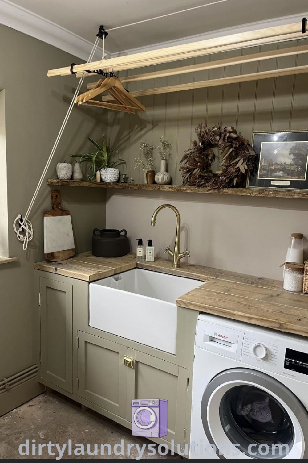 A stylish laundry room featuring a washer and dryer next to a window with open shelves, emphasizing cozy and functional utility ideas for small spaces. Discover more unique ideas for your home at dirtylaundrysolutions.com.