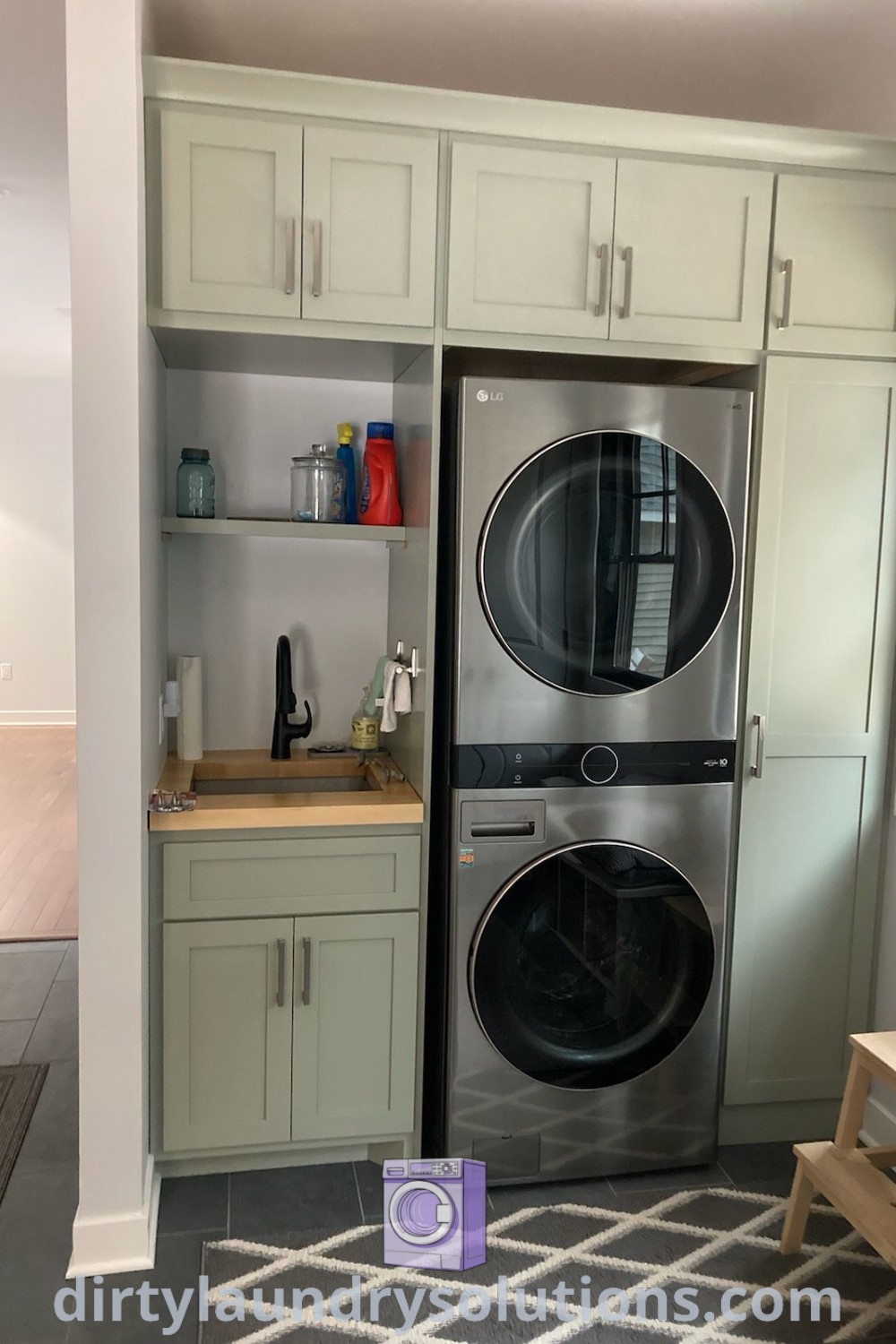 A small laundry room featuring a stackable washer dryer built into white cabinets, complete with a sink for added functionality. Explore cozy ideas and solutions for small spaces at dirtylaundrysolutions.com.