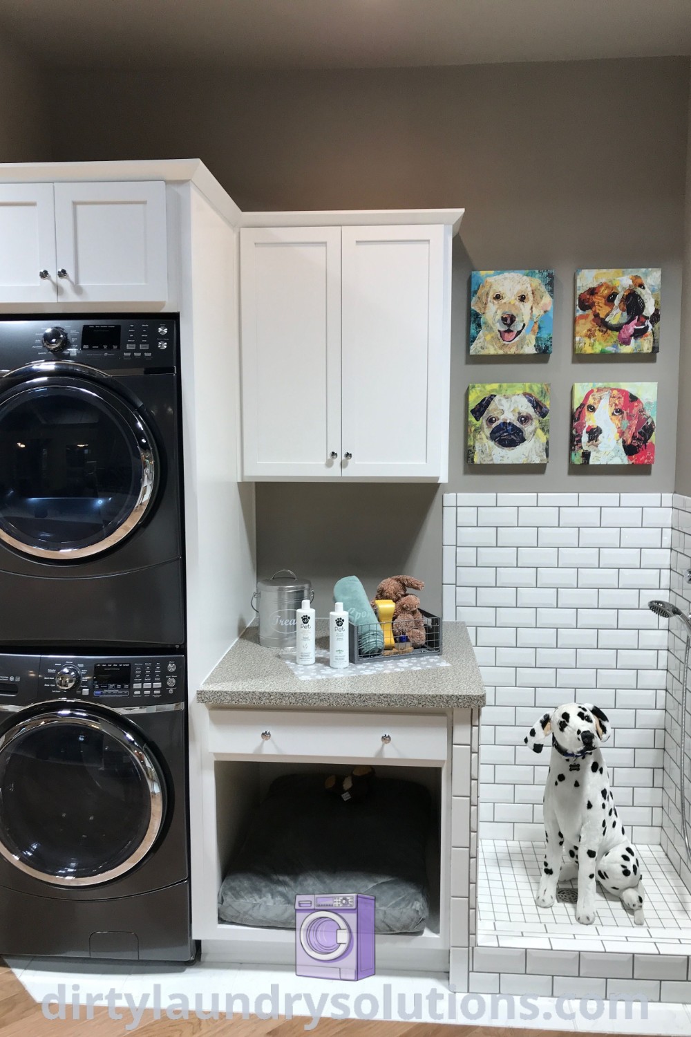 A cozy laundry room showcasing a washer and dryer in a small space with white tile walls, incorporating cabinets and shelving for storage. Discover inspiring ideas for small spaces and effective laundry room renovations at dirtylaundrysolutions.com.